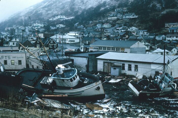 Abandoned boats wrecked near a coastal town, illustrating a dark turn related to being late in an emergency situation.