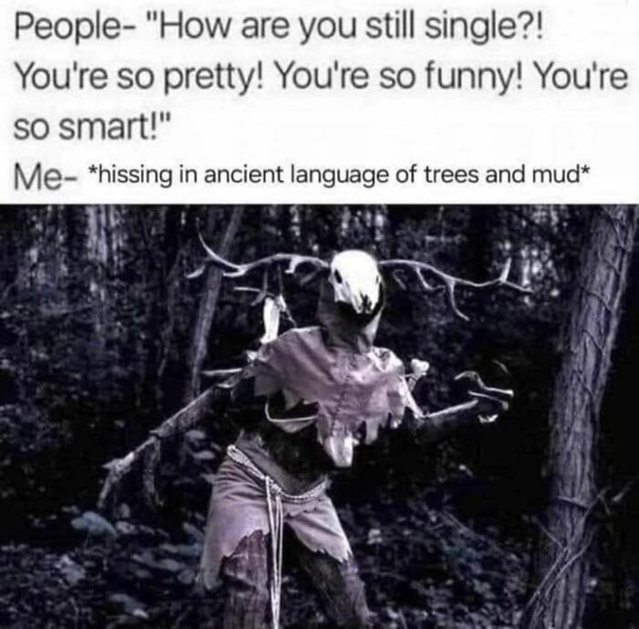 A goblin-like figure with a skull head and antlers, standing in a dark forest, for unhinged memes that make your inner goblin laugh.