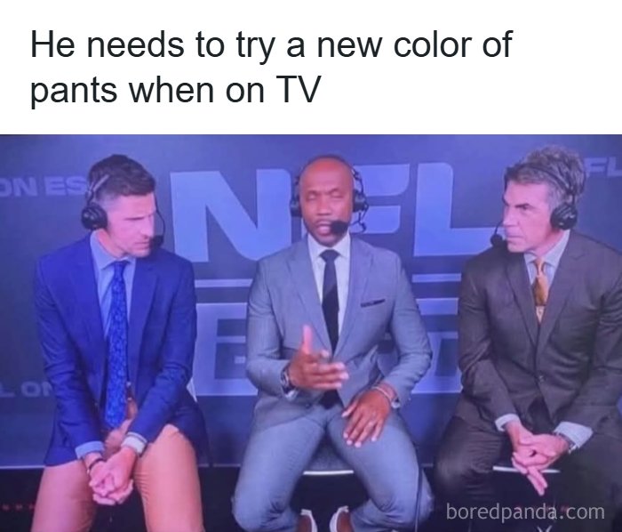 A TV personality in a blue suit and peach pants sits next to two men in suits, creating unhinged memes for your inner goblin.