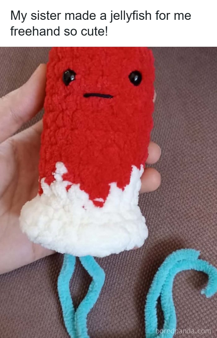 Handmade red and white fluffy jellyfish toy, a cute craft that might make your inner goblin laugh.