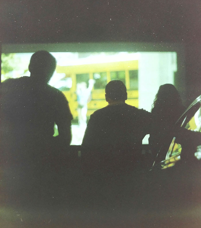 Three people silhouetted watching a blurred screen, illustrating creative and sneaky ways to successfully get a job.