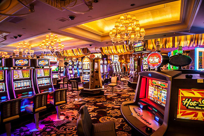 Casino interior filled with colorful slot machines and vibrant lighting showcasing creative job-seeking environments.