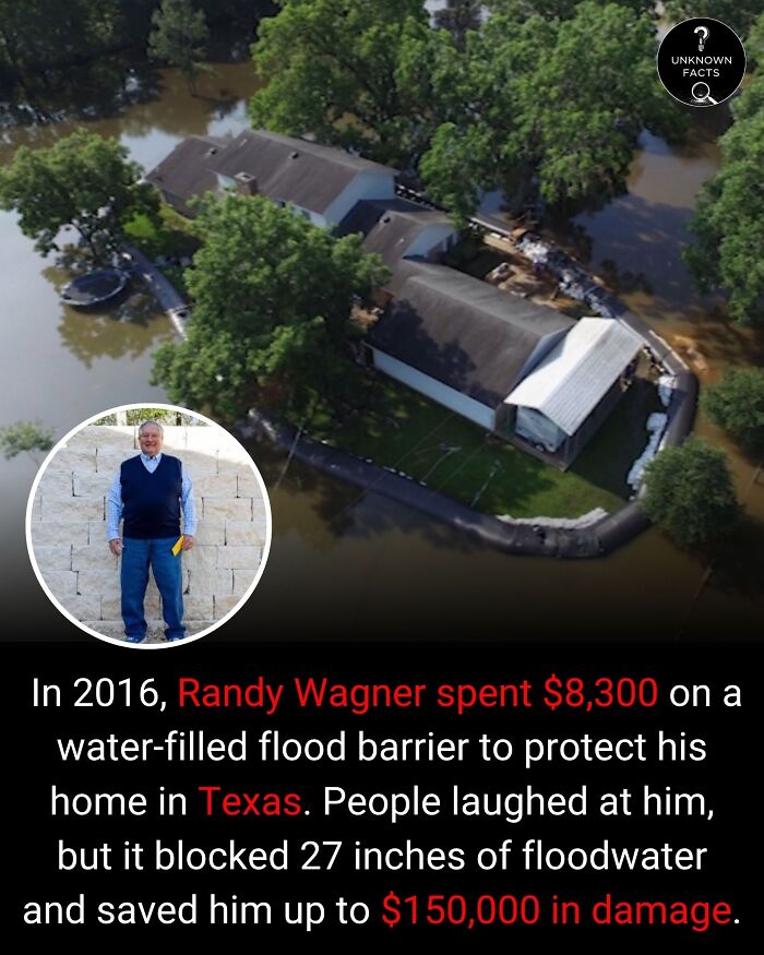 An aerial view of a flooded neighborhood with one house protected by a flood barrier, an interesting fact.