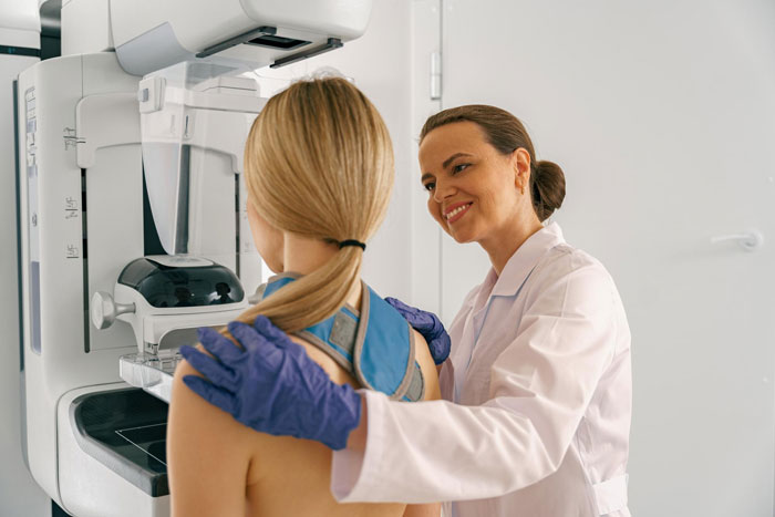 Woman undergoing cancer screening with a compassionate doctor during a medical exam for early detection and support.
