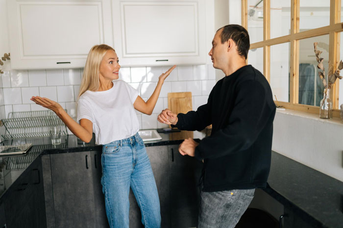 Man and wife arguing in kitchen over ex, highlighting issues in marriage leading to divorce after two months.