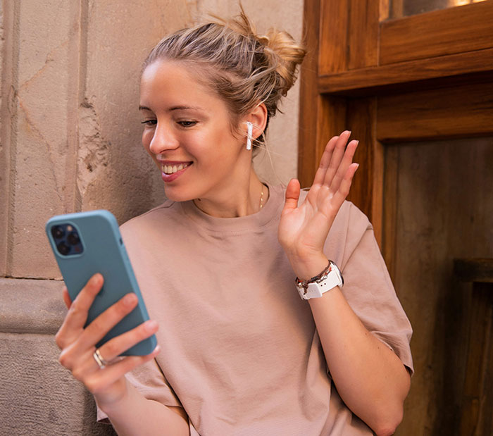 Woman accused of sleeping with sister&rsquo;s fianc&eacute; smiling while video chatting on phone wearing earbuds outdoors