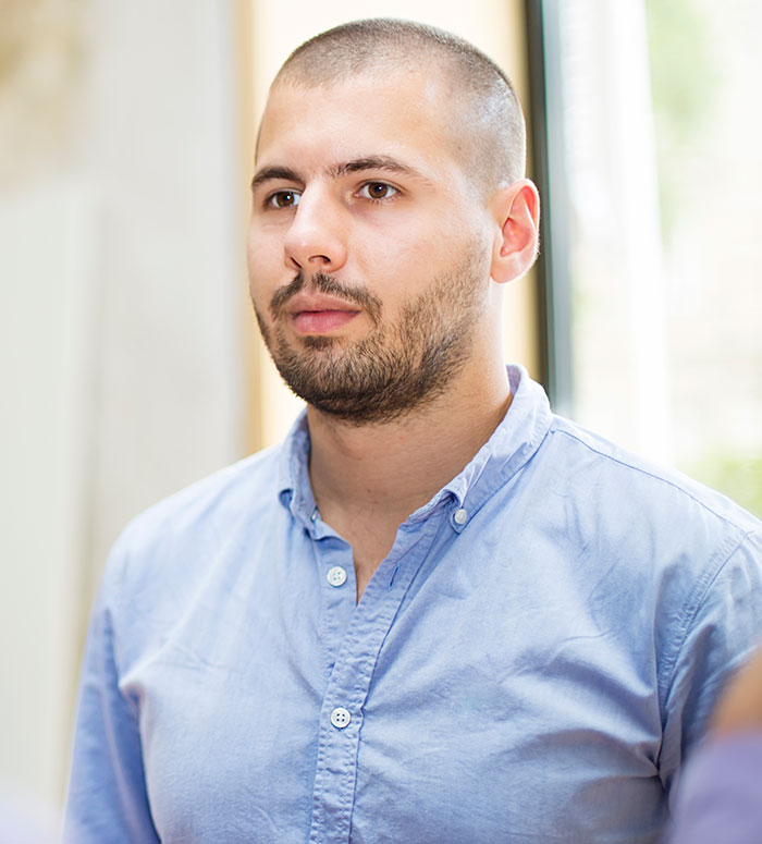 A young man with a buzz cut and beard, wearing a blue shirt. Boyfriends can be inconsiderate and dumb sometimes.
