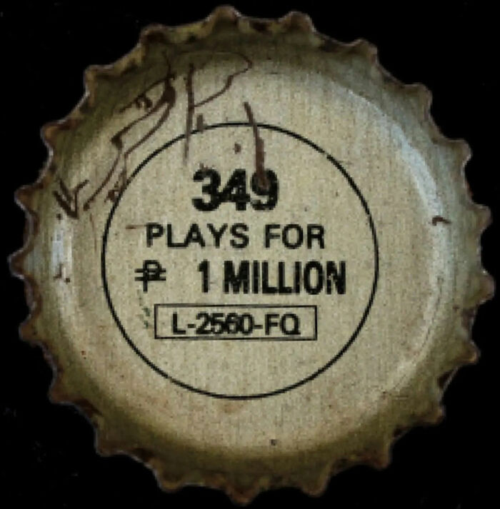 Worn bottle cap with faded text advertising a marketing fail promo promising one million plays for a code.
