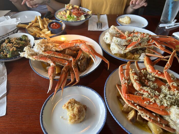 Seafood meal featuring crab legs, fries, and salad illustrating marketing fails with even big budgets.