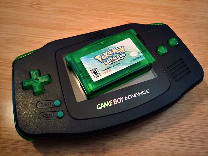 Black Game Boy Advance with Pokemon Emerald. Reliving retro games reminds us of past friendship betrayals.