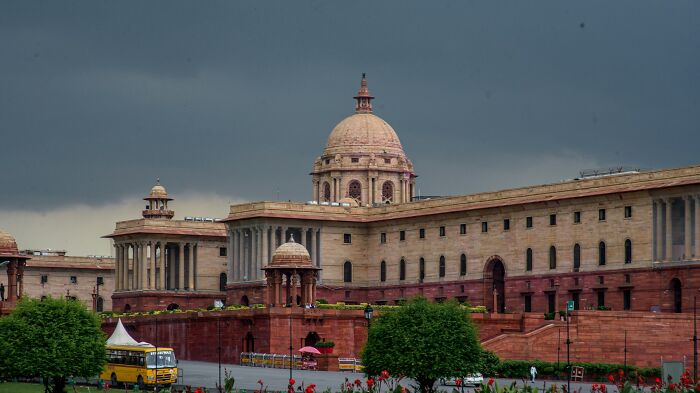 Historic government building under a dark sky, evoking a feeling connected to terrifying statistics and uneasy nights.