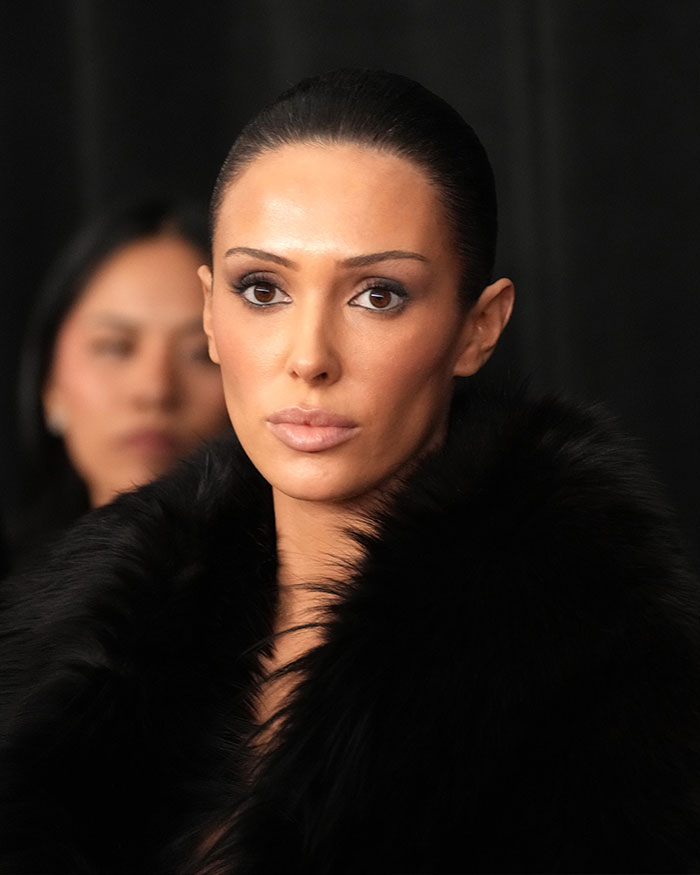 Bianca Censori in a black fur coat with slicked-back hair, showcasing her style after Kim Kardashian's Met Gala look. Bianca Censori in a black fur coat with slicked-back hair, showcasing her style after Kim Kardashian's Met Gala look.