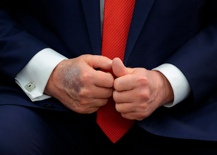 Close-up of President Trumps hands and red tie Close-up of President Trumps hands and red tie