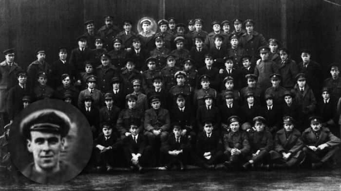 Old black and white group photo with unclear faces in uniform