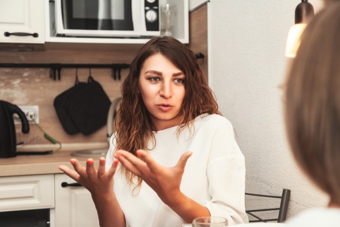 Woman explaining adoption reasons in a kitchen conversation Woman explaining adoption reasons in a kitchen conversation