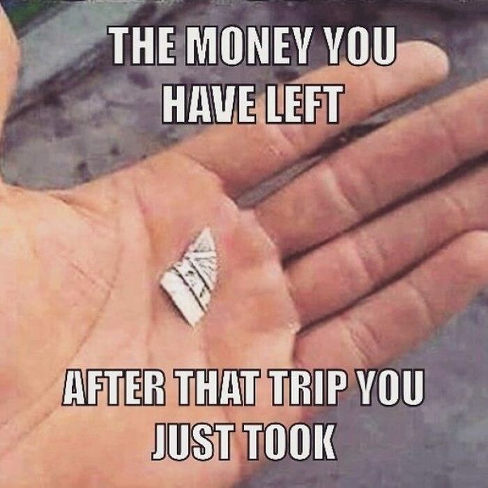 A hand holding a tiny, torn piece of money. A funny travel meme highlighting how little money is left after a trip.