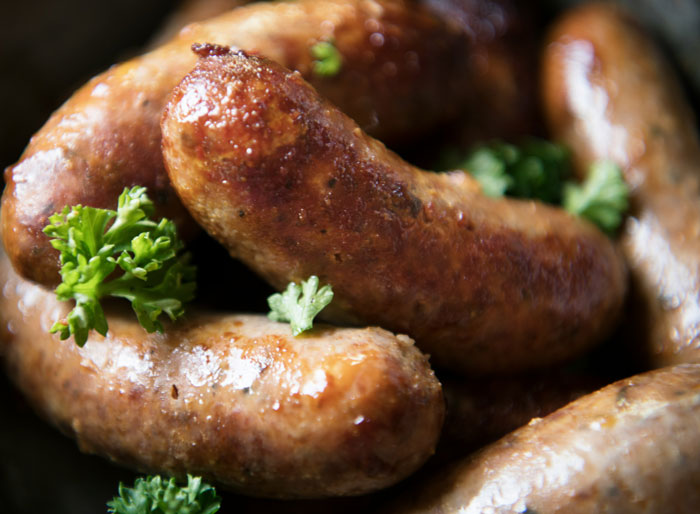Close-up of golden brown sausages with fresh parsley, highlighting one of the weirdest packages.