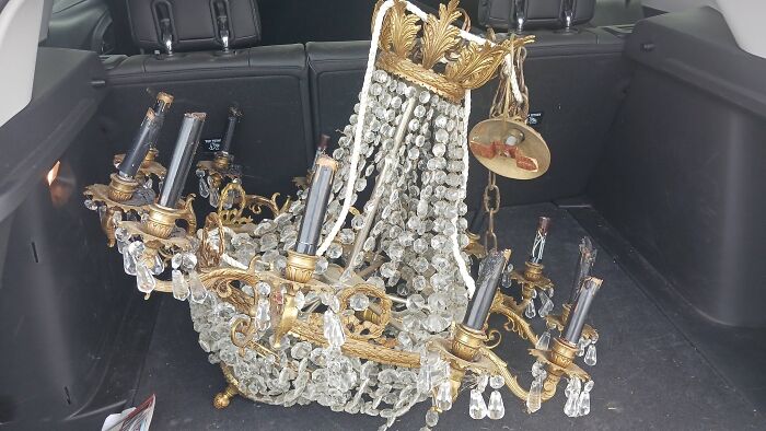 Crystal and brass vintage secondhand chandelier in car trunk