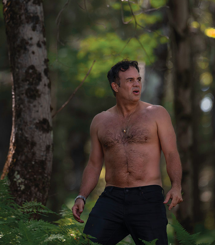 Shirtless man with dad bod standing in forest, body image study context