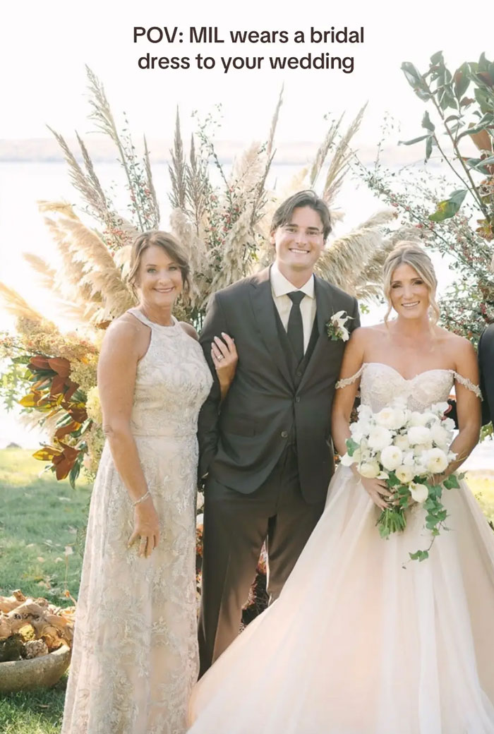 Mother-in-law in a light-colored dress with the groom and bride in her wedding dress at son’s wedding. Mother-in-law in a light-colored dress with the groom and bride in her wedding dress at son’s wedding.