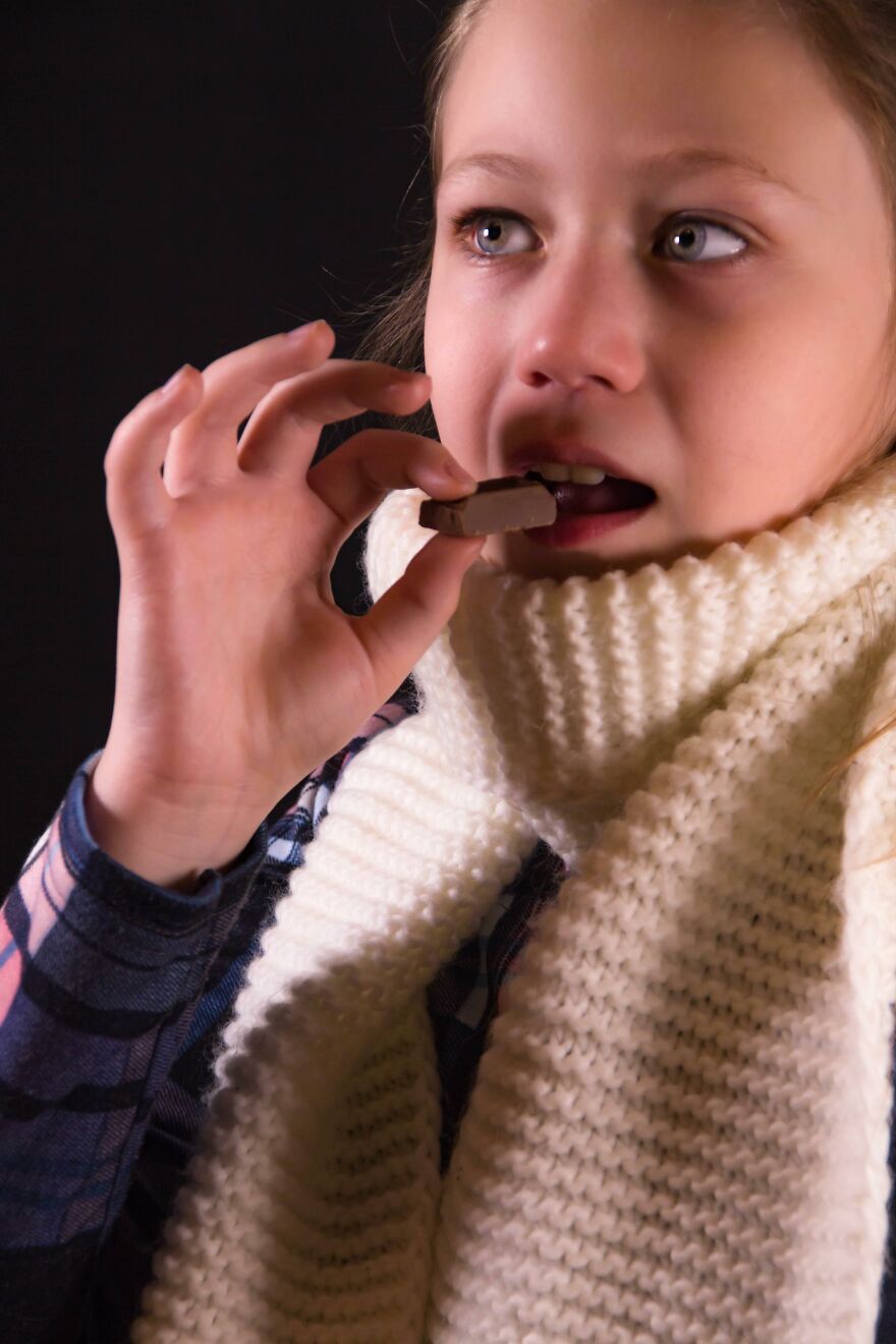 Girl eating chocolate as an easy mood booster