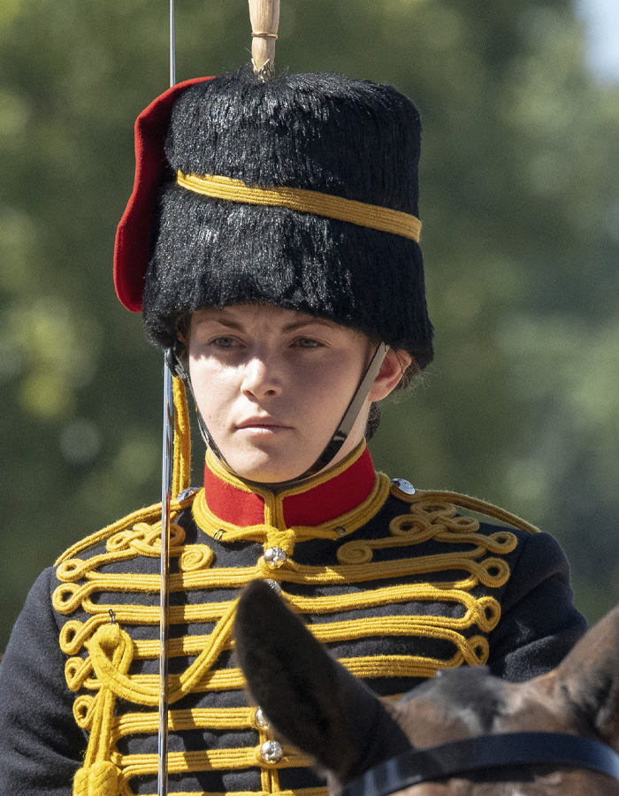 Close-up of female soldier in ceremonial uniform during horse show performance Close-up of female soldier in ceremonial uniform during horse show performance