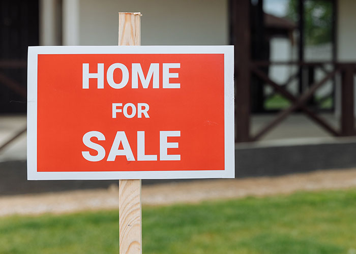 Home for sale sign illustrating abandoned property after mysterious disappearances