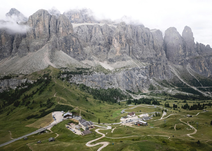 Mountain hotel surrounded by rugged peaks and green landscape in Italian Alps Mountain hotel surrounded by rugged peaks and green landscape in Italian Alps