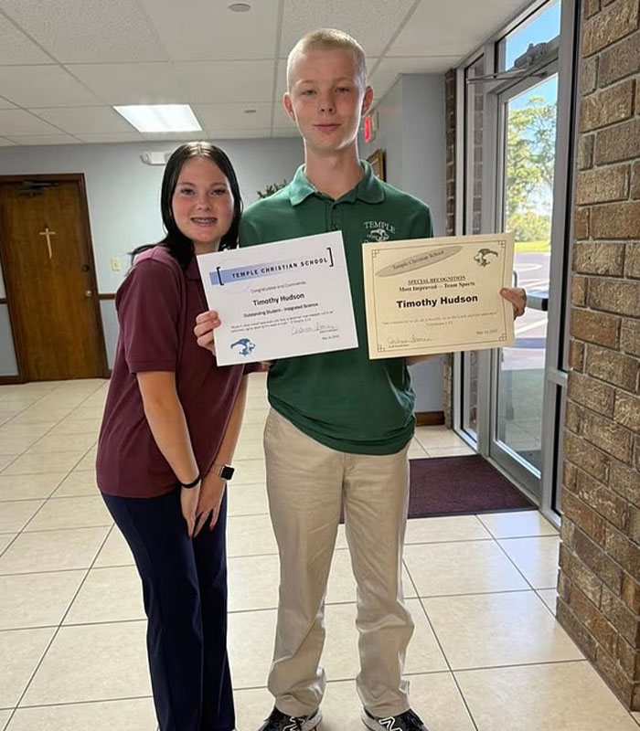 Teen holding certificates at Temple Christian School with sibling