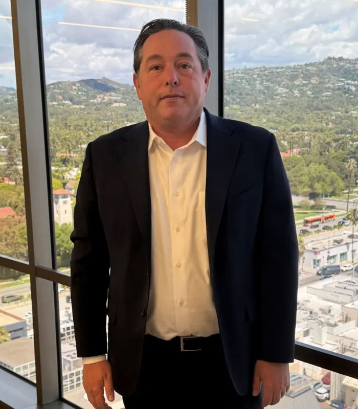 Portrait of a man in business attire in an office with city view, related to JPMorgan employee case Portrait of a man in business attire in an office with city view, related to JPMorgan employee case