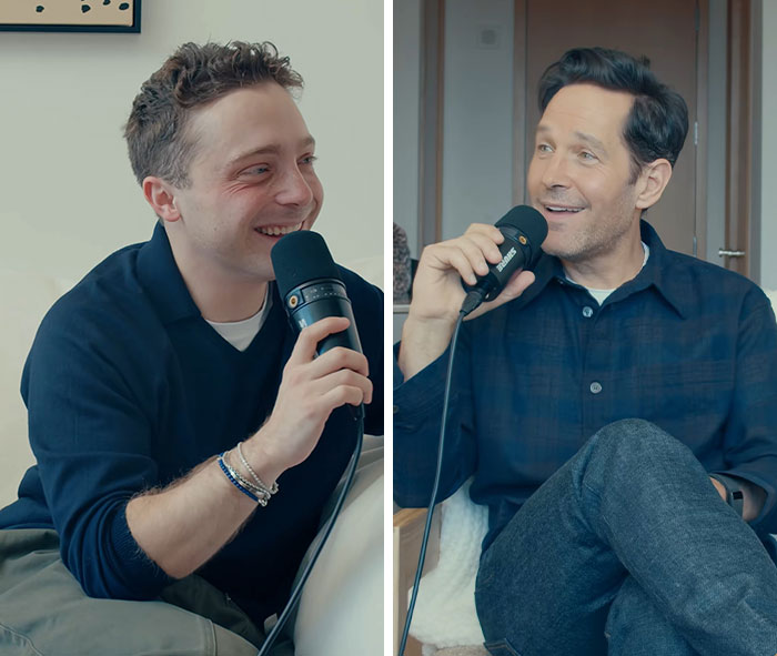 Paul Rudd and co-host speaking into microphones during an interview
