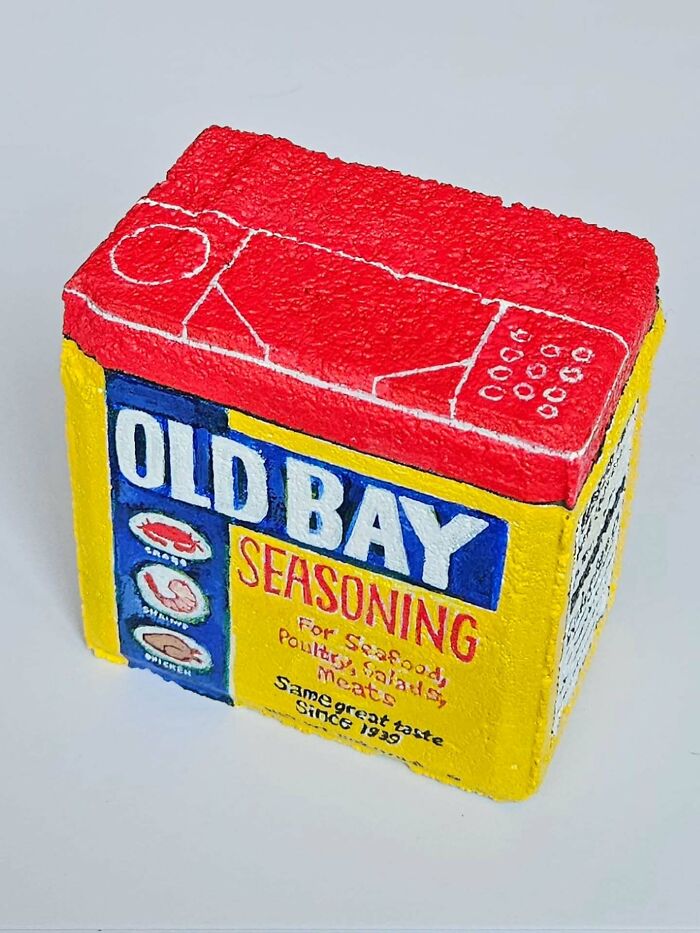 Colorful stone creation of an Old Bay Seasoning box, transforming a rock into an iconic food product.
