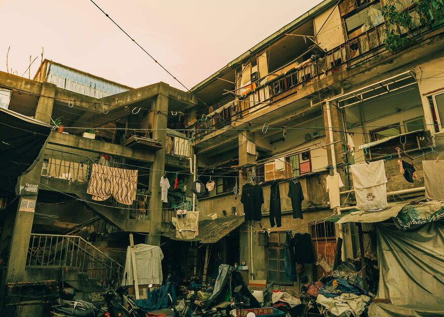 A dense, old apartment complex with laundry hanging to dry, reflecting conditions related to stressful jobs.