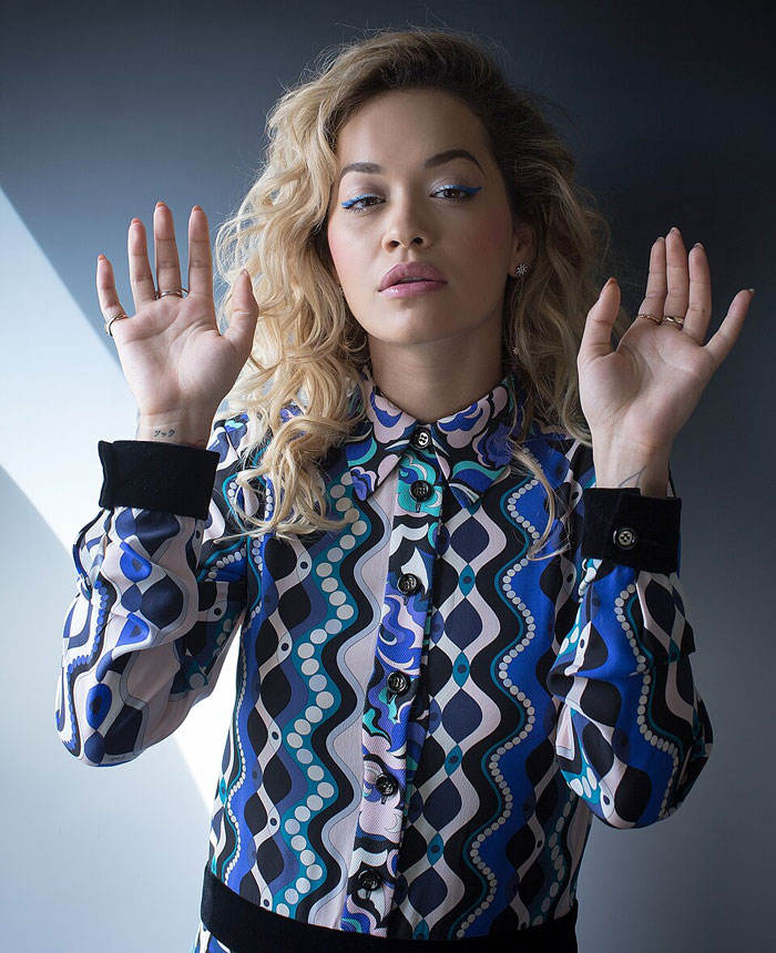Woman in patterned shirt with hands up illustrating PR fails