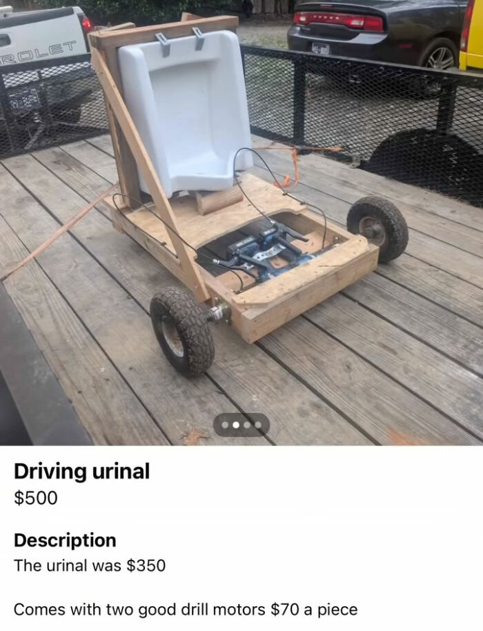 Driving urinal go-kart with drill motors on wooden platform and wheels