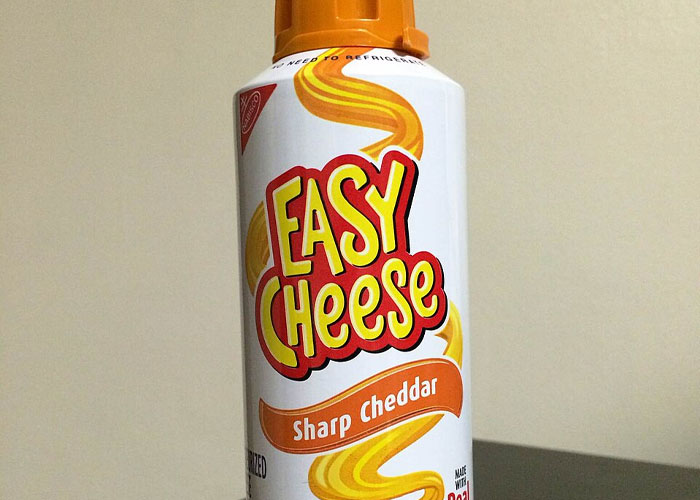 Close-up of a can of Easy Cheese Sharp Cheddar. Challenging stereotypes about the US with iconic products.