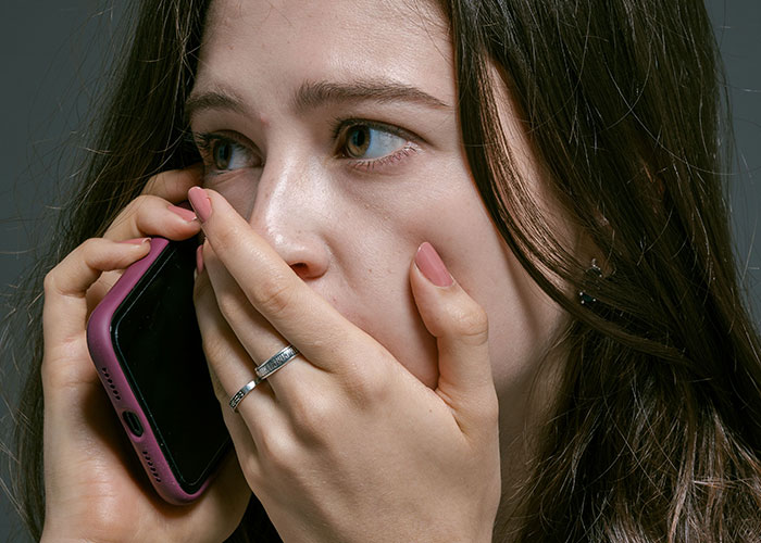 Worried woman on phone confused by minor inconvenience emergency