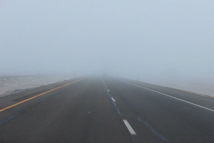 Foggy highway with low visibility illustrating laziness saving from disaster