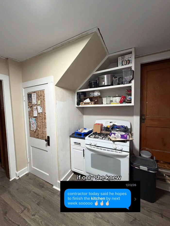 A messy kitchen in a home with exposed drywall, unfinished painting, and a stove covered in supplies, showing a woman's frustrating experience with a contractor.