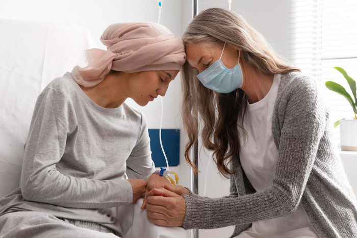 Supportive woman comforting patient during therapy session in hospital