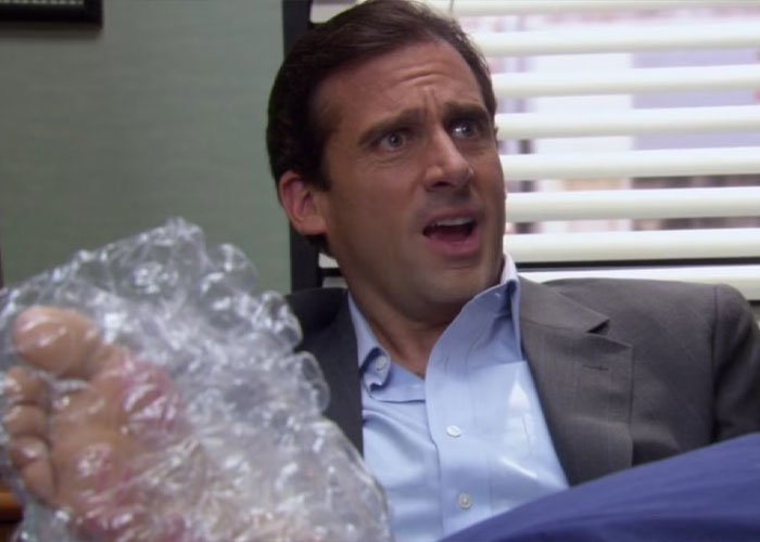 Man reacting to minor inconvenience with bubble wrap on foot