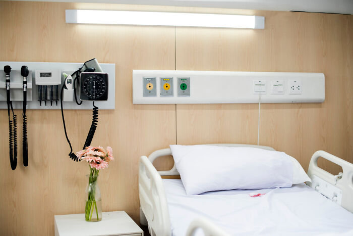 A hospital room with a medical bed, equipment, and flowers. Stories of crossing to the other side may involve such settings.