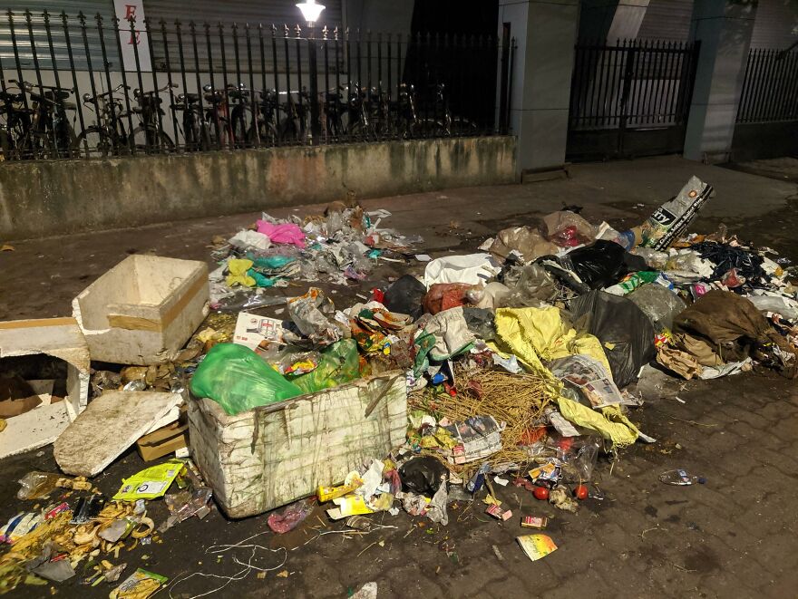 A large pile of trash and discarded items on a dirty street, reflecting one of the most stressful jobs.