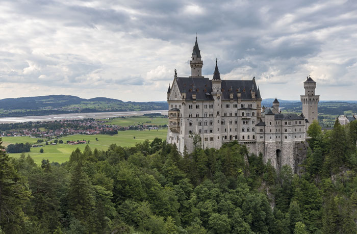 Neuschwanstein Castle perched on a hill, a famous European landmark admired by Americans