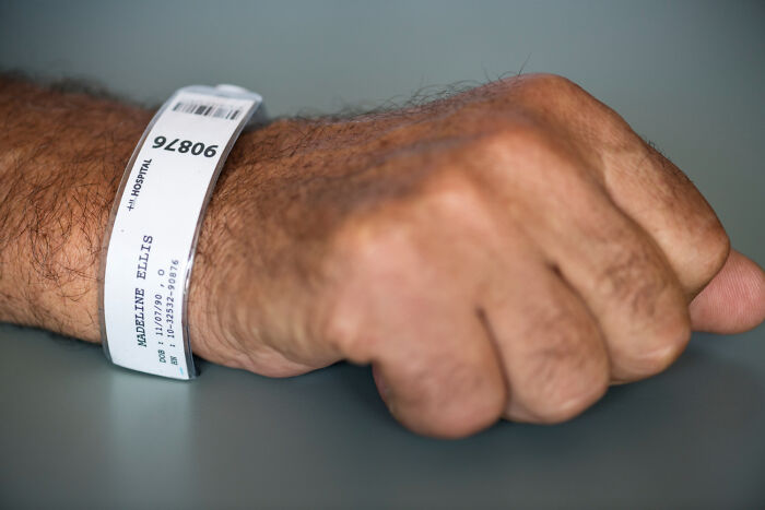 Hospital patient wristband on arm with medical information visible