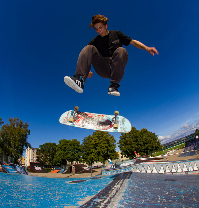 Skateboarder performing a jump trick at outdoor skatepark