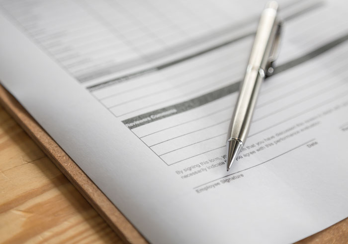 Pen on legal document ready for signature related to surrogacy Pen on legal document ready for signature related to surrogacy