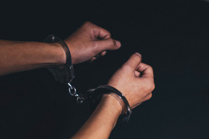 Hands in handcuffs symbolizing confinement in psychiatric facility