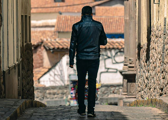 Man walking alone in narrow alleyway symbolizing mysterious vanished people
