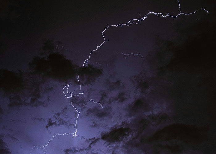 Lightning striking dark sky during minor inconvenience emergency